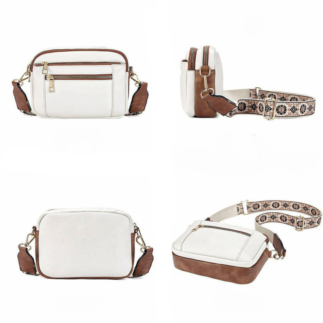 Elegante Damen Handtasche aus schwarzem Kunstleder mit farbigem Blumenriemen. Modisches und praktisches Accessoire.
