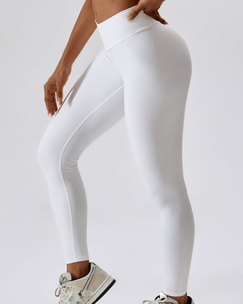 Dynamische orangefarbene Damen Fitnesshose mit weißen Details. Hoher Bund & perfekte Passform.