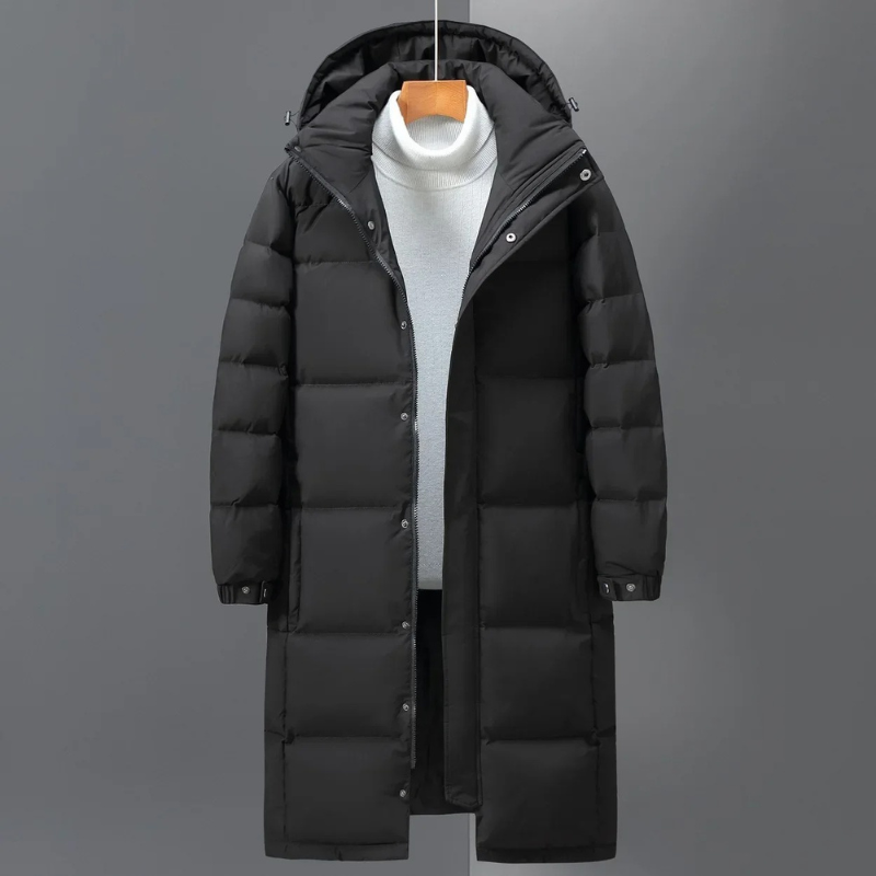 Grauer stilvoller Herren Steppmantel mit Kapuze. Warme, lange Winterjacke für Schutz und Komfort in der Herrenmode.