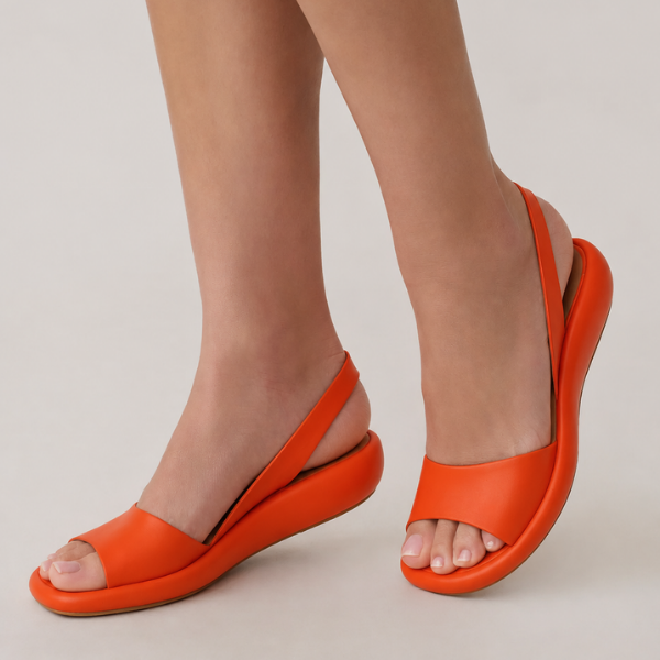 Damen orthopädische Sandalen in Orange an den Füßen getragen