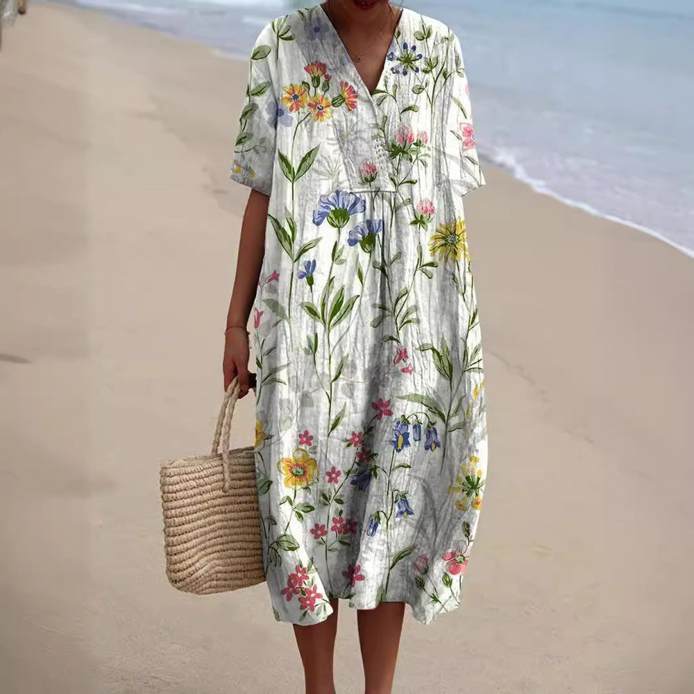 Elegantes Sommerkleid Talia für Damen mit tiefem V-Ausschnitt und farbenfrohem floralen Print.
