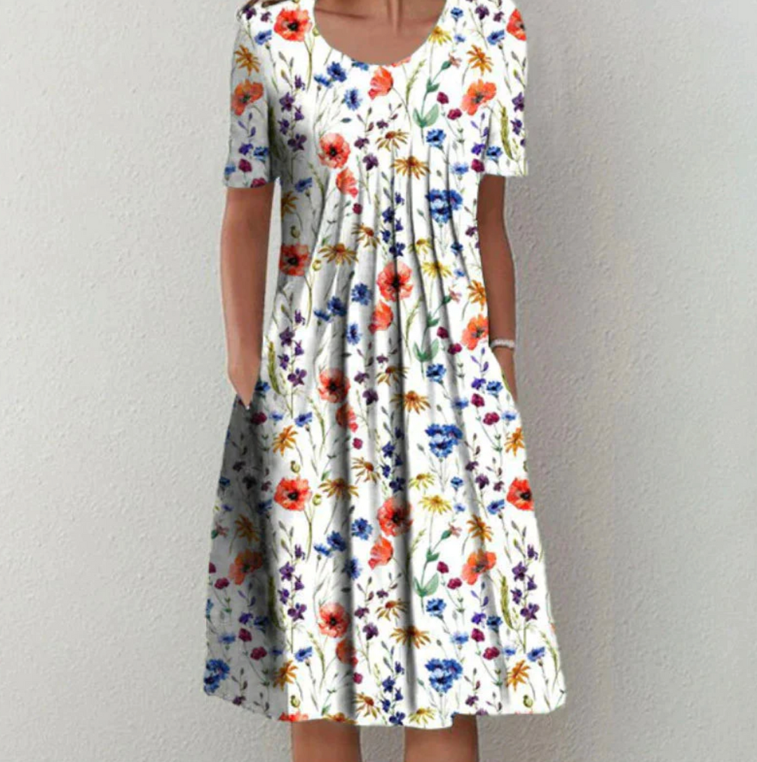 Damen Blumen Midikleid mit lockerem Schnitt für sommerliche Eleganz. Ideal als Freizeit- oder Strandkleid.