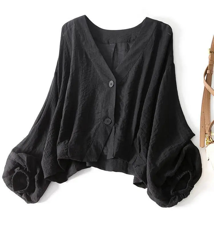 Schwarzes Oversized Sommeroberteil für Damen: Bluse mit modernen Ballonärmeln und V-Ausschnitt.