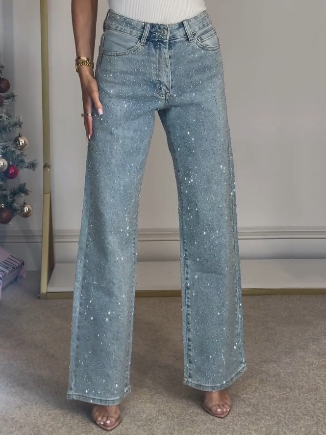 Elegante Damenjeans in Blau, High Waist Schnitt mit Glitzer-Details und modischem Bootcut-Schlag.