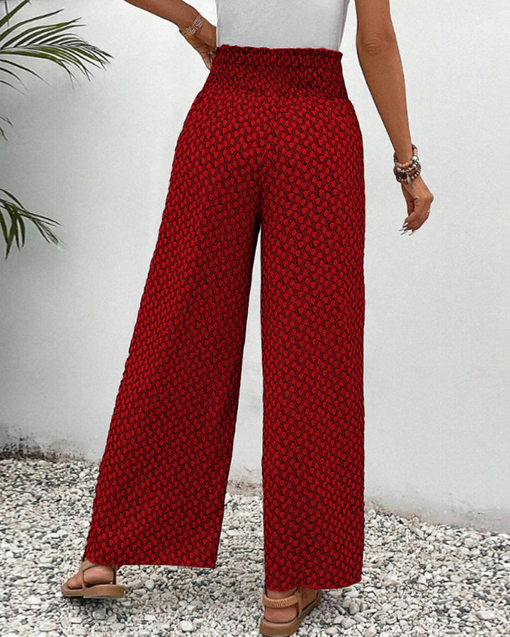 Rot, grün und schwarz gemusterte Damenhose mit weitem Bein. Stylisch und bequem für Freizeit & Sommer.