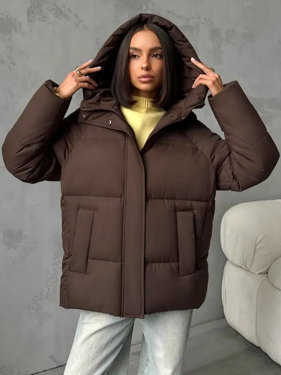 Seitenansicht: Moderne Oversized Damen Winterjacke mit Kapuze, ideal für Outdoor-Aktivitäten.
