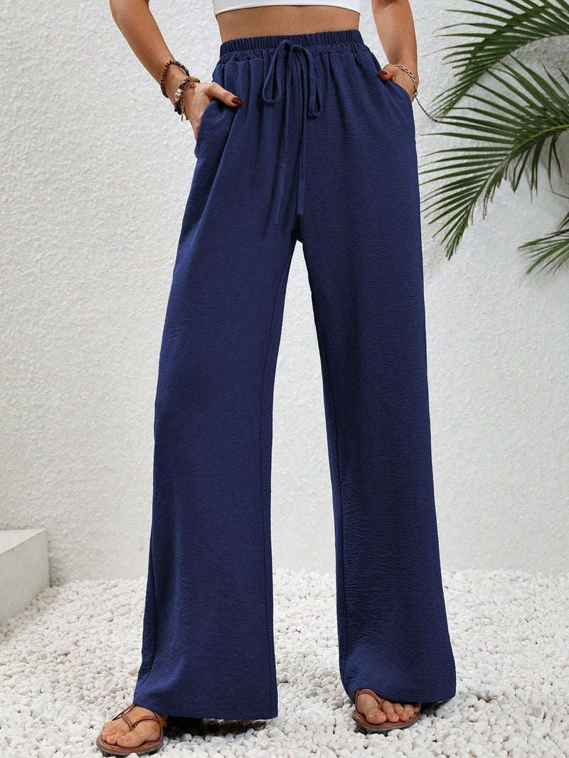 Damen Strandhose in Hellbeige, weit geschnitten, mit hohem Bund und Kordelzug, sommerlich-elegant.