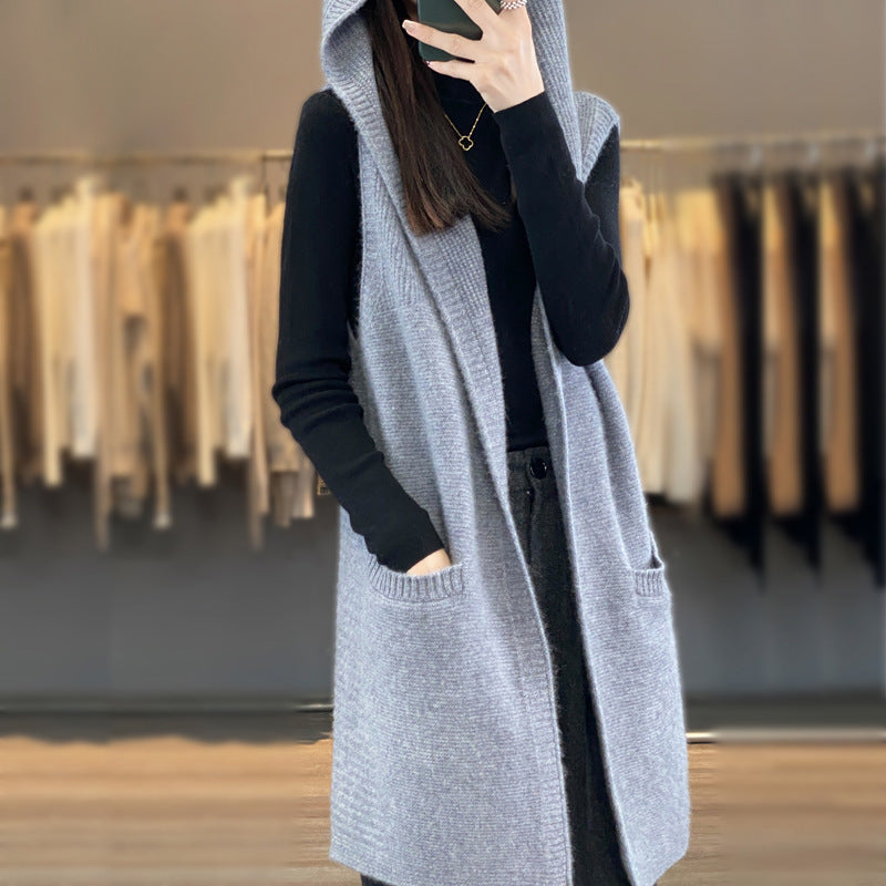 Detailreiche Damen Strickweste mit Kapuze. Lange, gestrickte Weste mit Taschen. Perfekt für Herbst/Winter.