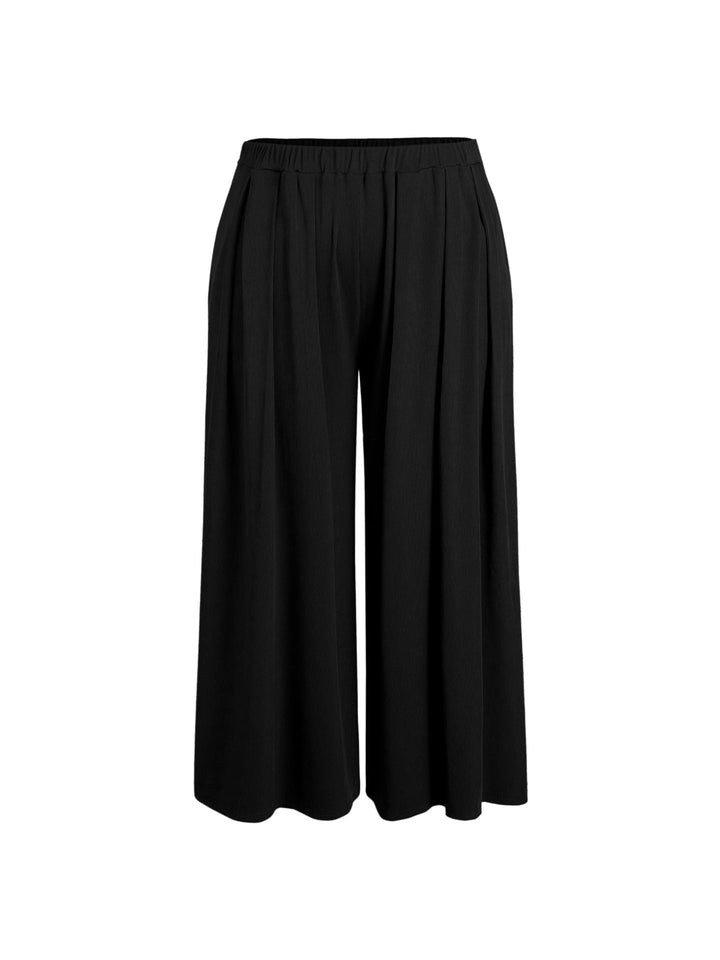 Beige weite Palazzohose für Damen, Detailaufnahme des elastischen Komfortbundes und des eleganten fließenden Stoffes.