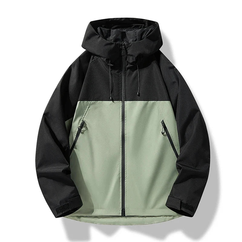 Aktiver Mann trägt wasserdichte Herren Outdoorjacke mit Kapuze beim Wandern in der Natur.