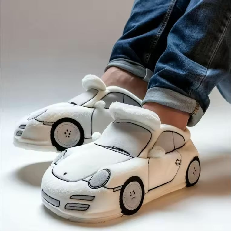 Mann trägt gemütliche Herren Winterhausschuhe "AutoLuxe" mit Fahrzeug-Design auf Holzboden; warme Pantoffeln.