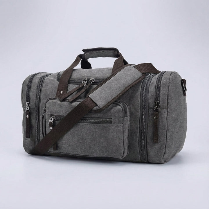 Graue, erweiterbare Canvas-Reisetasche. Praktische Wochenendtasche, Sporttasche oder Handgepäck für Ihre Reise. Unisex.