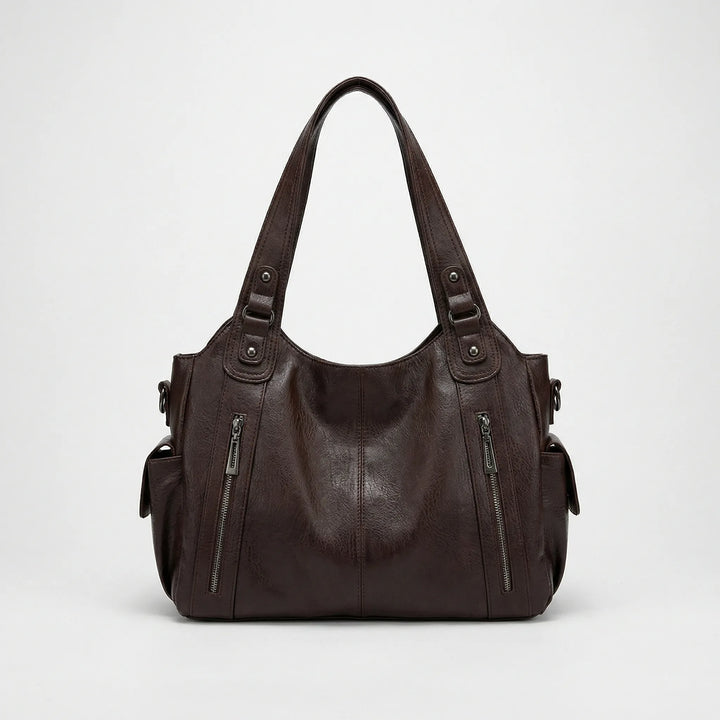 Nikita Crossover Tasche in klassischem Schwarz, vielseitig als Schultertasche und Damentasche.