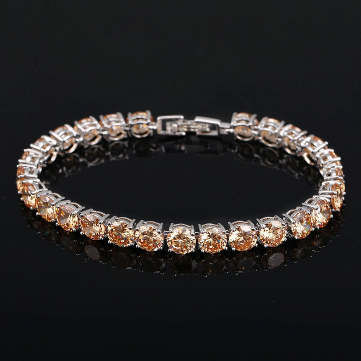Damen Glitzerarmband: Roségoldenes Tennisarmband aus Messing mit strahlendem Kristallherz und Zirkonia.