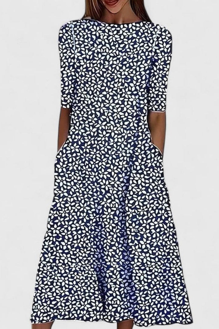 Damen Kurzarm A-Linie Kleid mit floralem Muster, elegantem Rundhals und praktischen Taschen für sommerliche Anlässe.