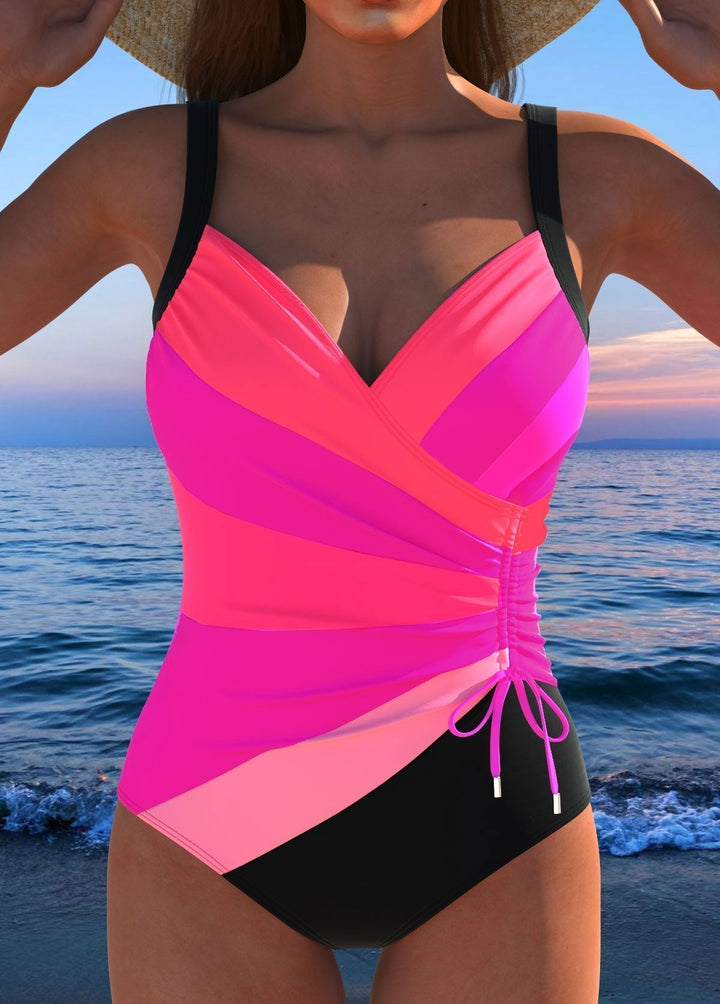 Eleganter Damen Einteiler mit Überkreuz-Design und lebhaftem Druck. Stilvolle Bademode für Pool & Strand.