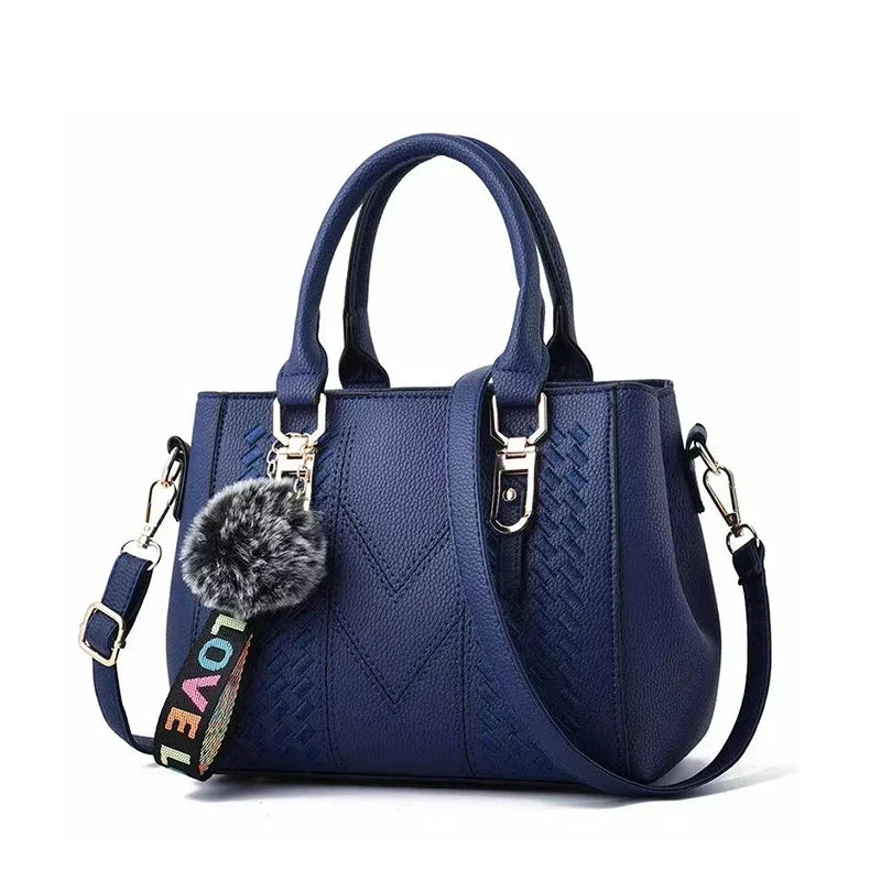 Elegante Damen Lederhandtasche mit modischem Pompon-Detail, perfekt für Alltag & Abend. Zeitloses Accessoire.