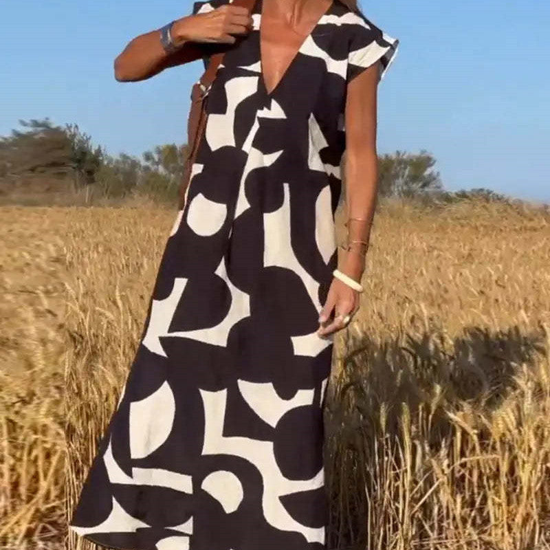 Damen Sommer Maxikleid mit V-Ausschnitt, locker geschnitten und farbenfroh bedruckt für Freizeit und Strand.