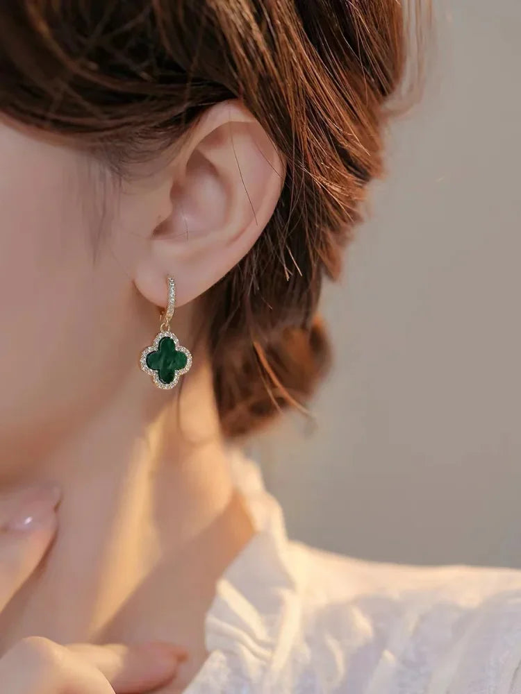 Glänzende Damenohrringe mit zarten Kleeblättern, vergoldeter Schmuck für einen eleganten Look.