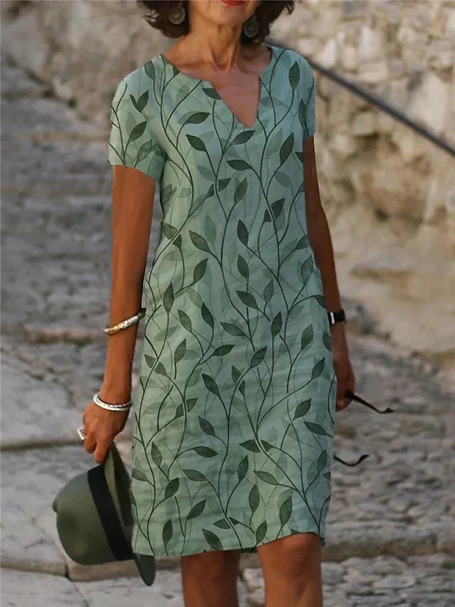 Damen Musterkleid Smaragdgrün mit elegantem V-Ausschnitt und kurzen Ärmeln, ideal als Sommer-Midikleid.
