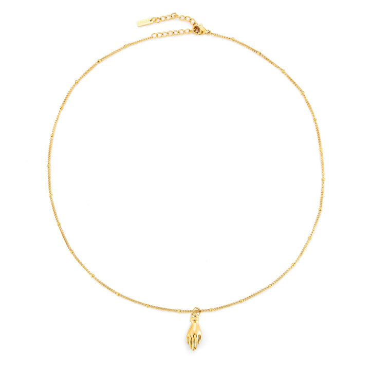Glänzende Damenhalskette goldfarben mit Schutz Hand Anhänger und grünem Zirkon. Symbolischer Edelstahlschmuck.