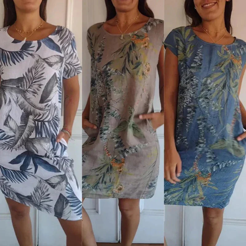 Modisches Sommerkleid für Damen mit auffälligem botanischen Print, Rundhals und praktischen Taschen.
